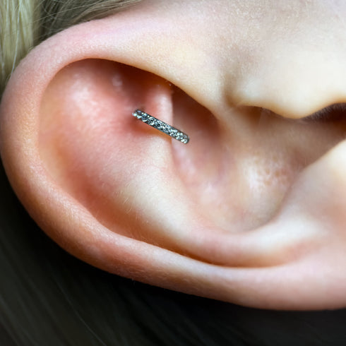 Close op of an ear with a small ring in rook piercing.